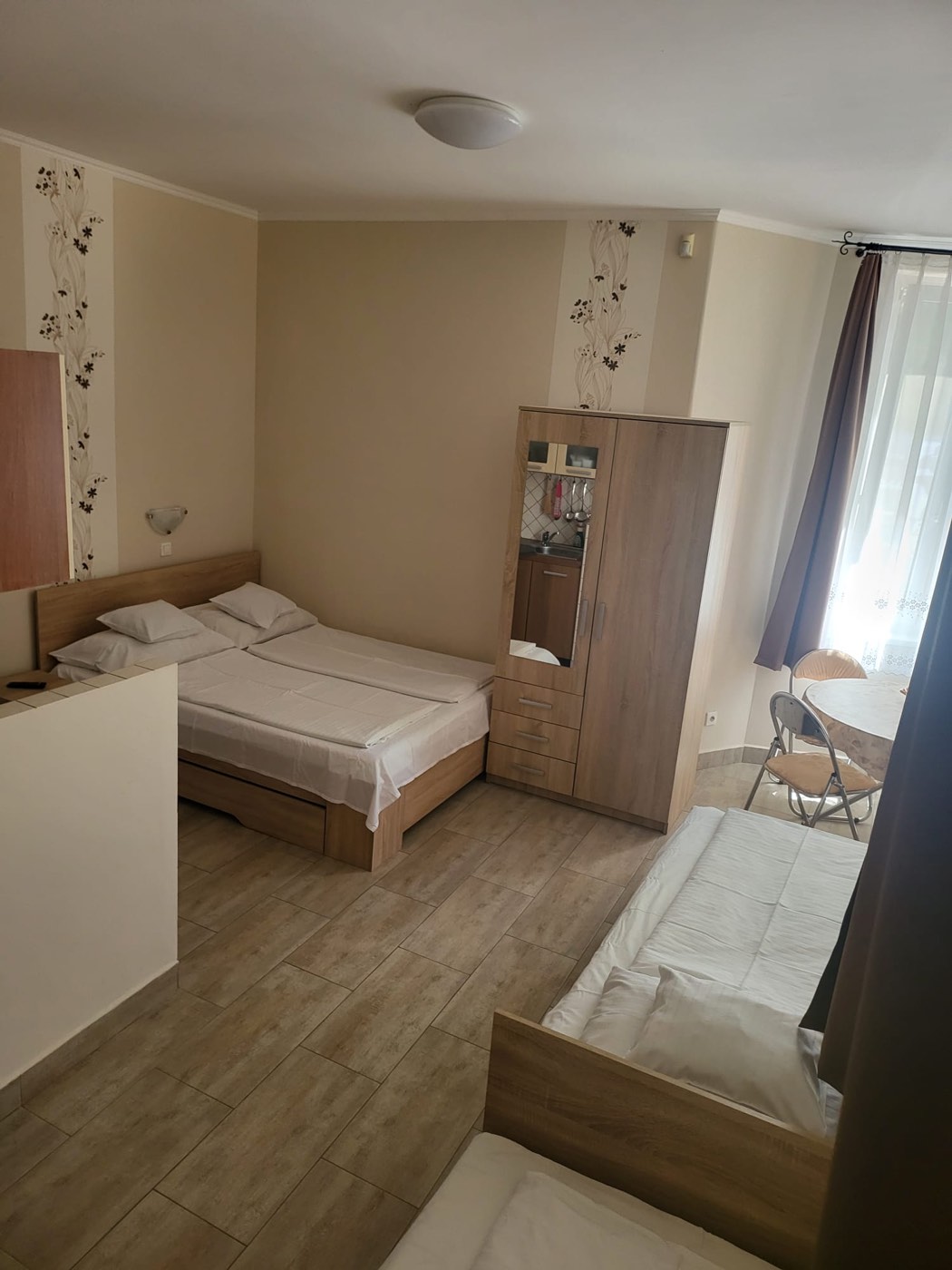 Négyfős apartman hálórésze franciaággyal és külön ágyakkal a Krisztina Villában